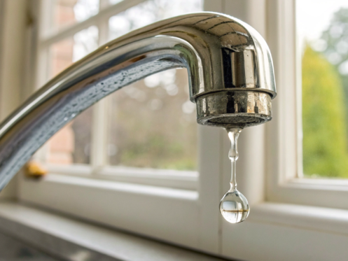 A dripping faucet causing a water leak, a problem solved by water leak detection.