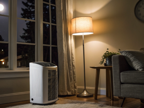 An AC unit in a dark living room needing immediate 24 hour AC repair.